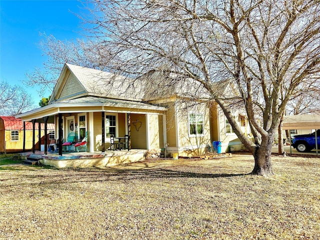 exterior space featuring a porch and a storage shed