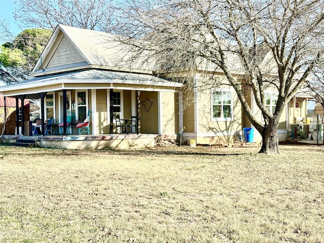 view of front of property with a front yard and a porch