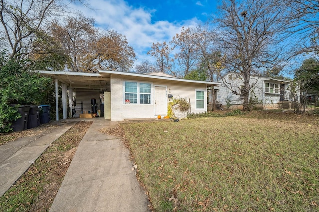 single story home with a front lawn and a carport