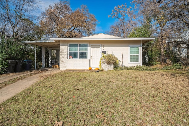 ranch-style house featuring a front yard and a carport