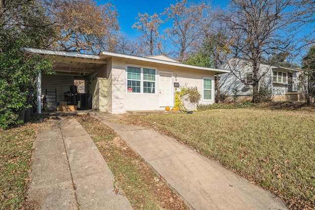 single story home with a front lawn and a carport