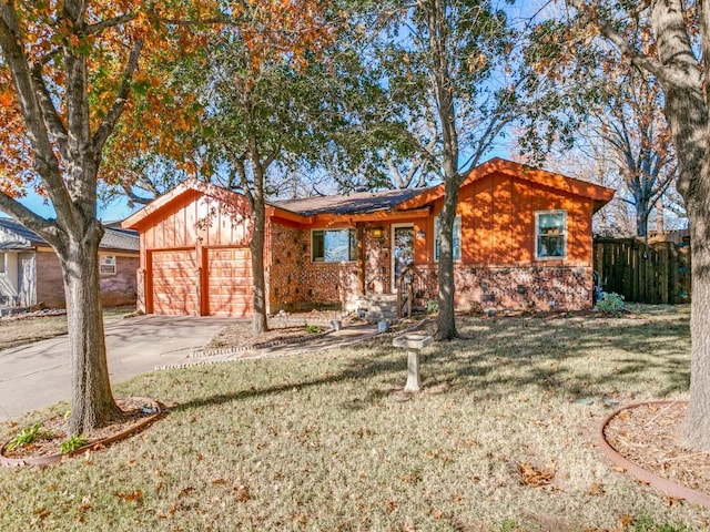 ranch-style house with a front yard and a garage