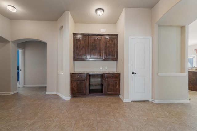 bar featuring dark brown cabinets