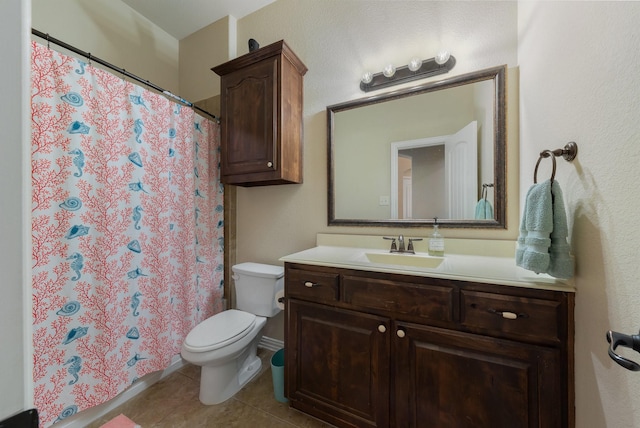 bathroom featuring tile patterned floors, vanity, and toilet