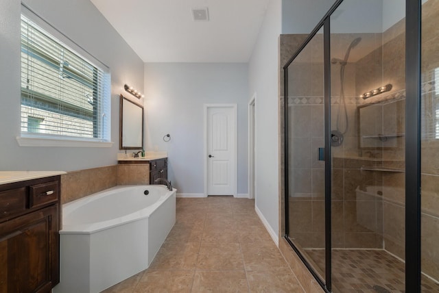 bathroom featuring tile patterned floors, vanity, and plus walk in shower