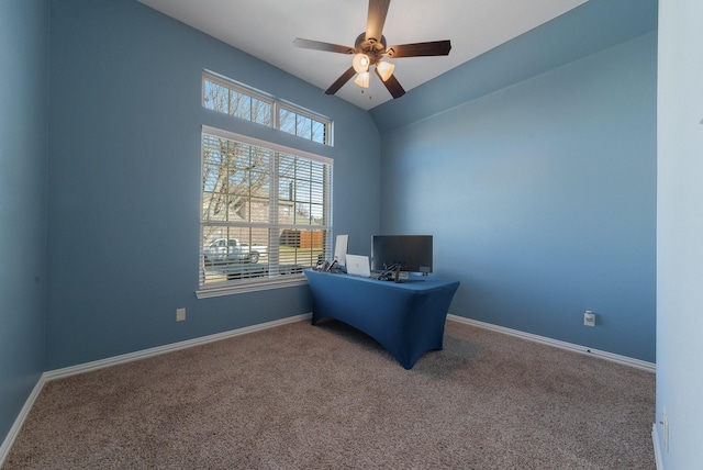 carpeted home office with ceiling fan and vaulted ceiling