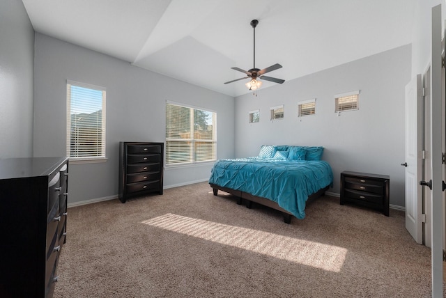 bedroom with carpet, multiple windows, ceiling fan, and lofted ceiling