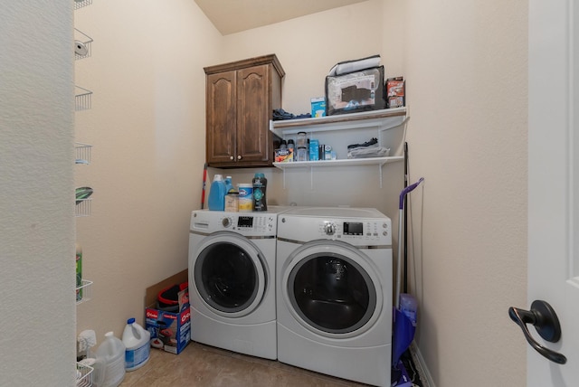 washroom with cabinets and washing machine and dryer