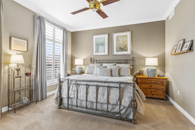 carpeted bedroom with ceiling fan and crown molding