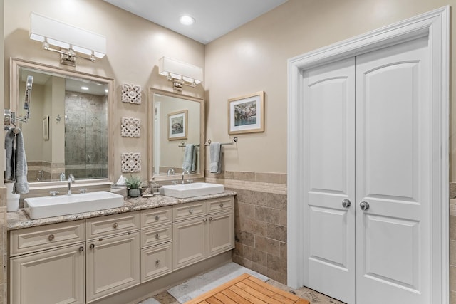 bathroom with vanity and a shower with door