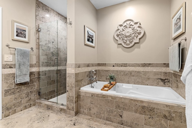 bathroom with separate shower and tub and tile walls