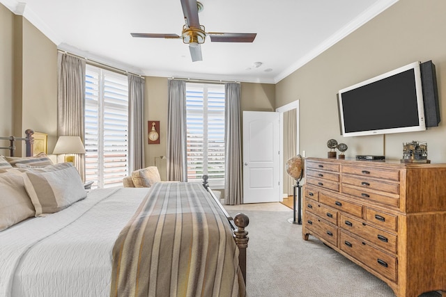 bedroom featuring ceiling fan, crown molding, and light carpet