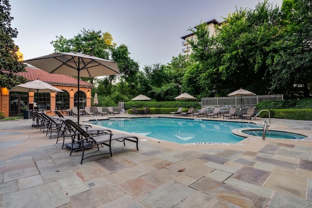 view of swimming pool featuring a community hot tub and a patio