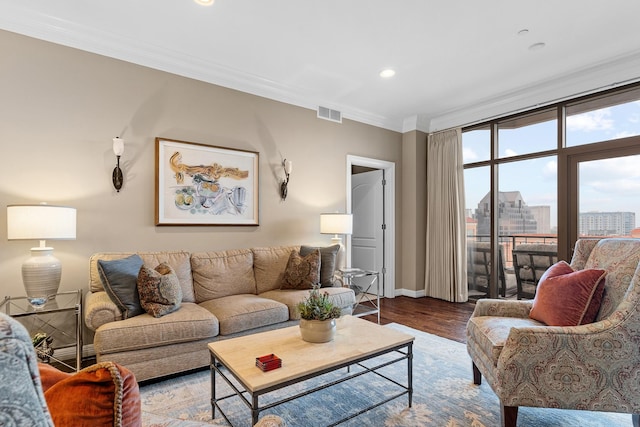 living room featuring hardwood / wood-style flooring and ornamental molding