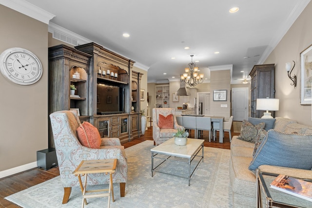 living room featuring a chandelier, light hardwood / wood-style floors, and ornamental molding