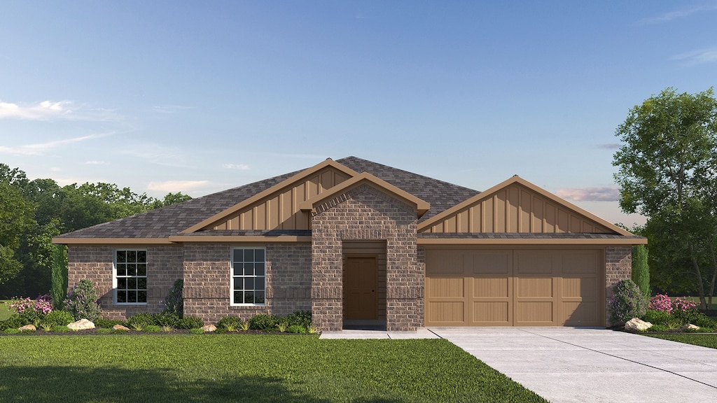 view of front of property featuring a front yard and a garage