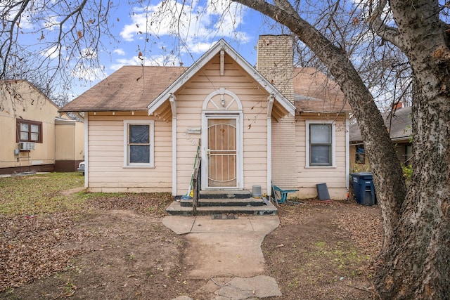 bungalow-style home with cooling unit