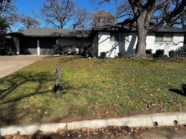 view of front of house with a carport and a front lawn