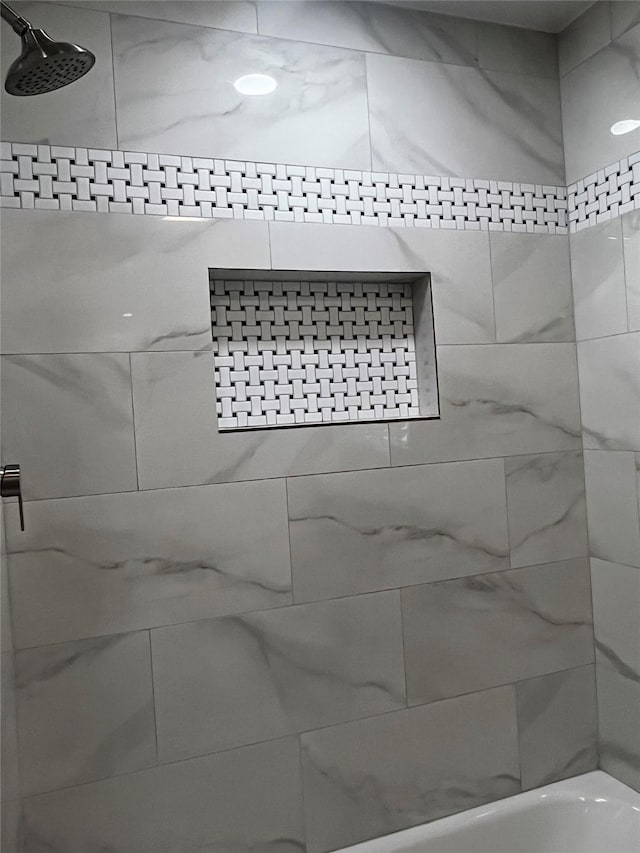 details with tiled shower / bath combo