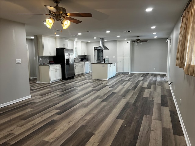 kitchen with backsplash, stainless steel fridge, island range hood, dark hardwood / wood-style flooring, and white cabinetry