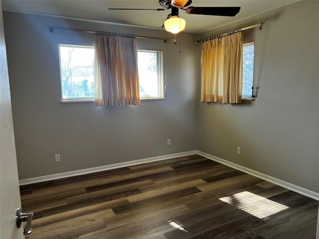 empty room with dark hardwood / wood-style flooring and ceiling fan