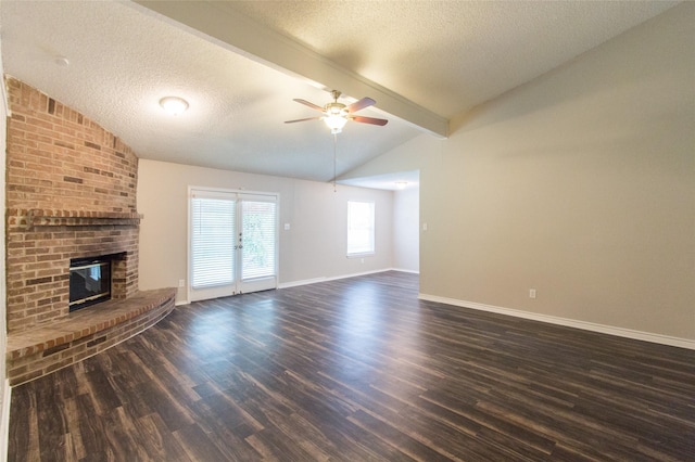 unfurnished living room featuring ceiling fan, dark wood-type flooring, lofted ceiling with beams, and a textured ceiling