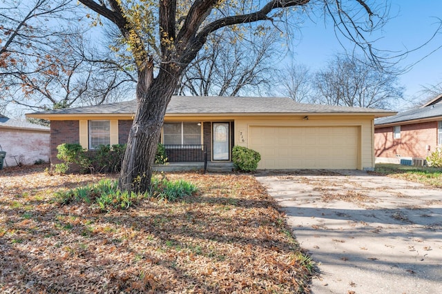 single story home featuring a garage and central AC unit