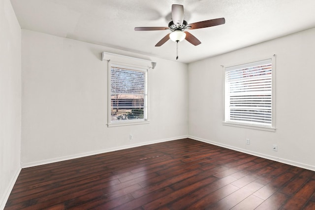 unfurnished room featuring ceiling fan and dark wood-type flooring