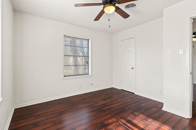 spare room featuring ceiling fan and dark hardwood / wood-style flooring