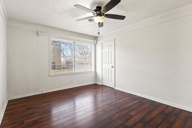 spare room with dark hardwood / wood-style floors, ceiling fan, and ornamental molding