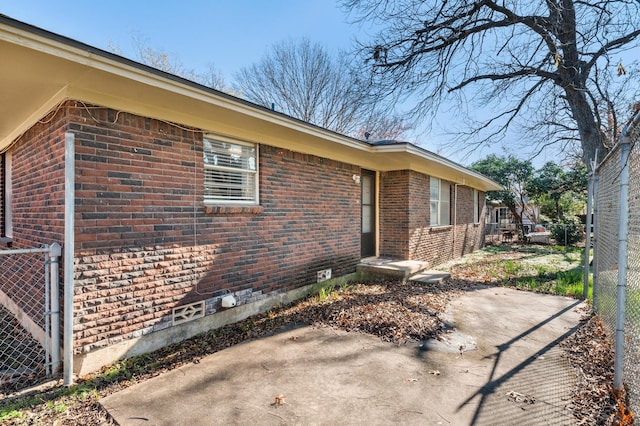 view of side of property with a patio area