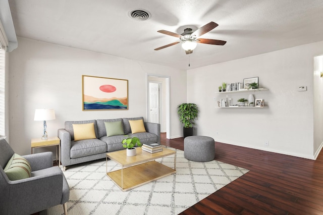 living room with wood-type flooring and ceiling fan