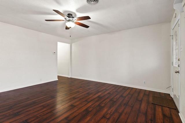 spare room featuring dark hardwood / wood-style floors and ceiling fan