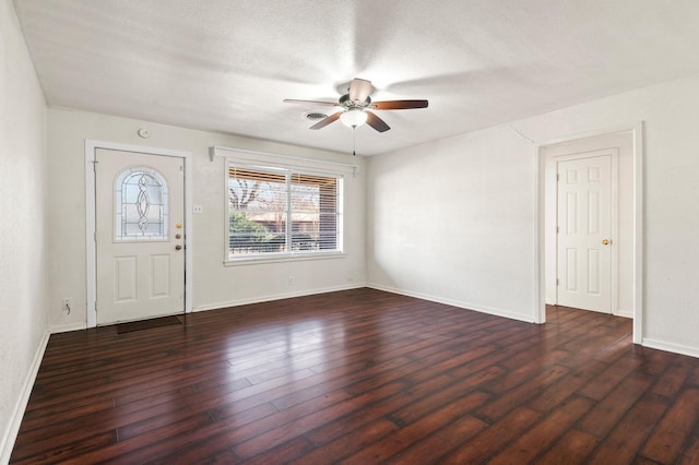 foyer entrance with ceiling fan, dark hardwood / wood-style flooring, and a textured ceiling