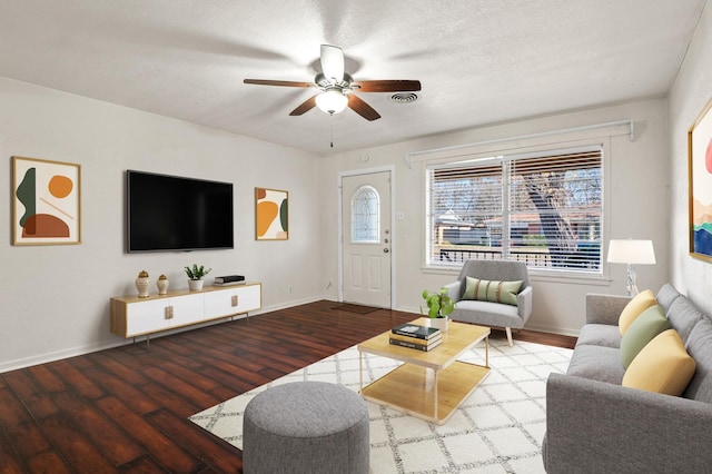 living room with ceiling fan, wood-type flooring, and a textured ceiling