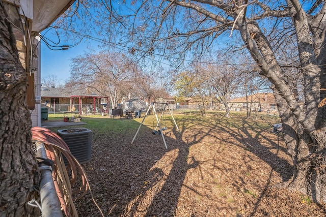 view of yard with central AC and a playground