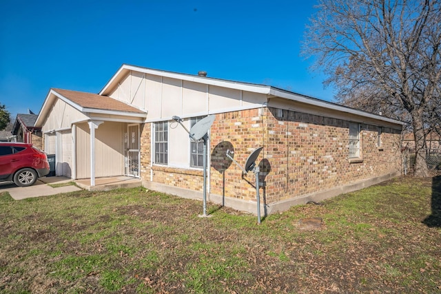 view of side of home with a yard and a garage