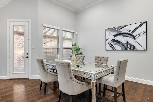 dining space featuring dark hardwood / wood-style flooring and crown molding