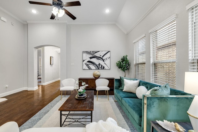 living room with crown molding, ceiling fan, vaulted ceiling, and hardwood / wood-style flooring