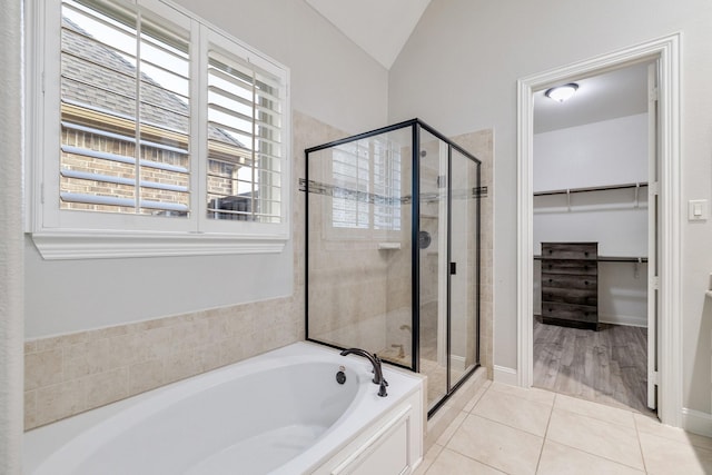 bathroom with tile patterned floors, lofted ceiling, and independent shower and bath