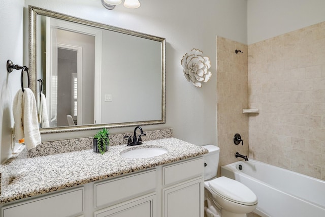 full bathroom featuring toilet, vanity, and tiled shower / bath