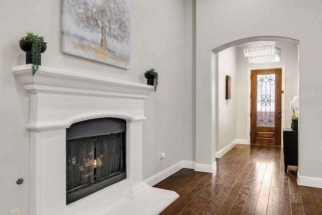 entryway with a chandelier and dark hardwood / wood-style flooring