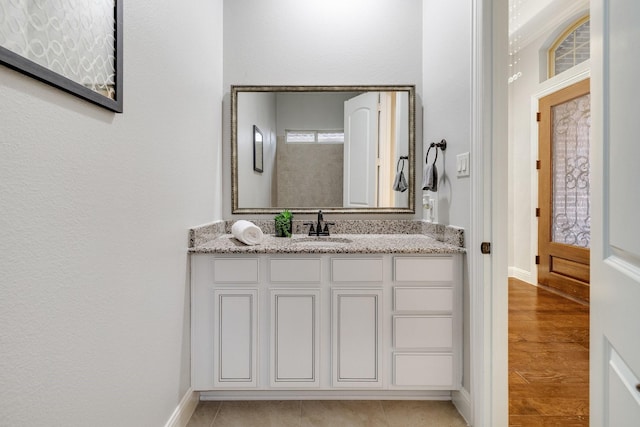 bathroom with tile patterned floors and vanity