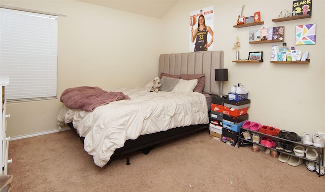 bedroom with lofted ceiling and light colored carpet