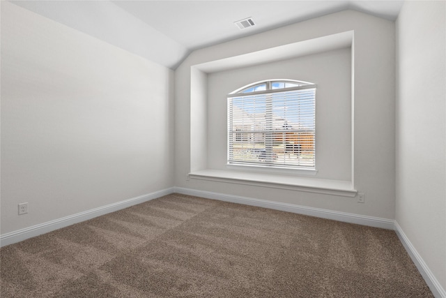 carpeted empty room with lofted ceiling