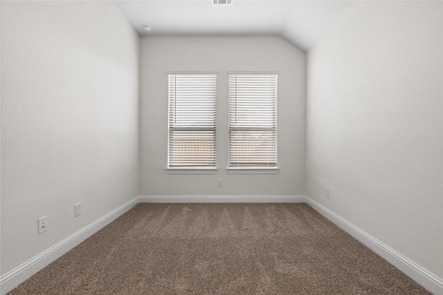 unfurnished room featuring vaulted ceiling and carpet floors