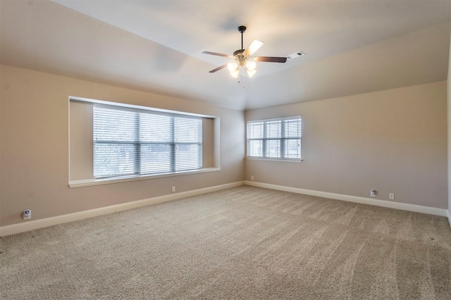 unfurnished room with carpet, ceiling fan, and vaulted ceiling