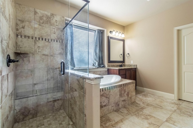 full bath with a stall shower, tiled bath, baseboards, and vanity