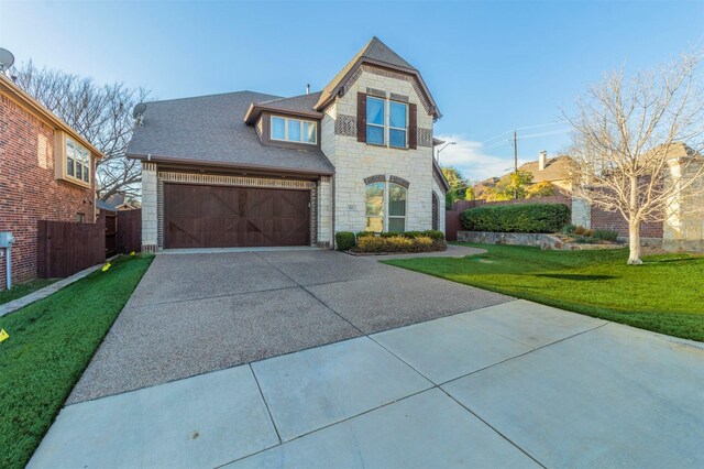 view of front of home with a garage and a front yard