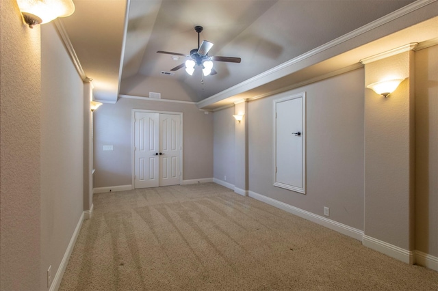 interior space with baseboards, visible vents, ceiling fan, vaulted ceiling, and carpet flooring